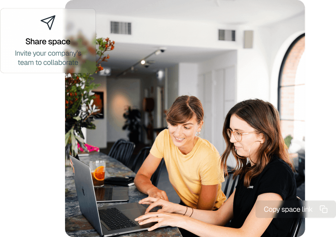 Two women collaborating on a laptop